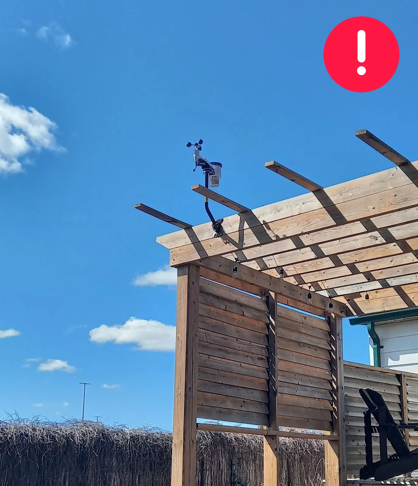WeatherXM station mounted only slightly above a wooden structure